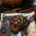 Juicy Salisbury steak patties topped with a rich mushroom gravy on a white plate.