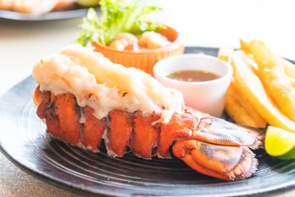 Step-by-step demonstration of cutting a lobster tail shell to expose the meat