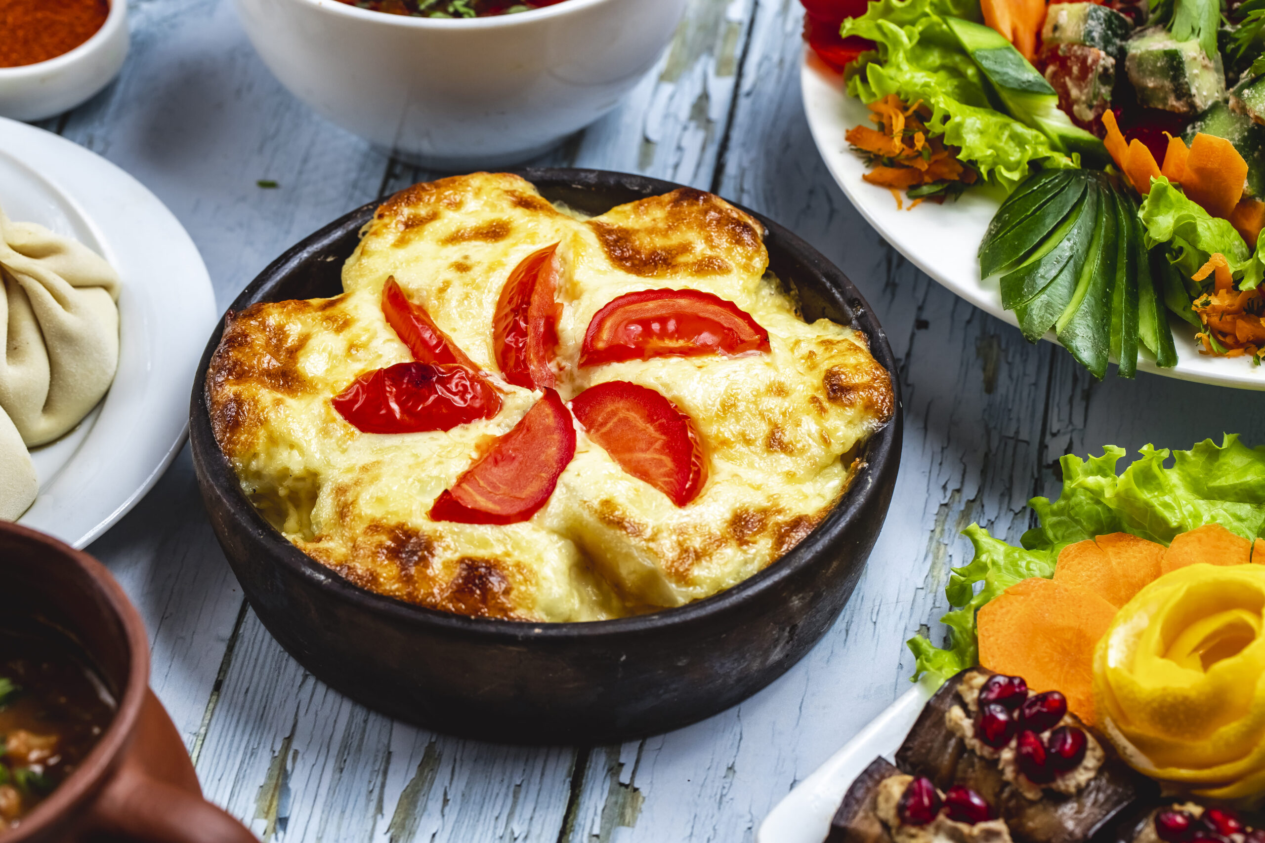 "Freshly baked cottage cheese in a casserole dish with golden edges and sprinkled herbs."