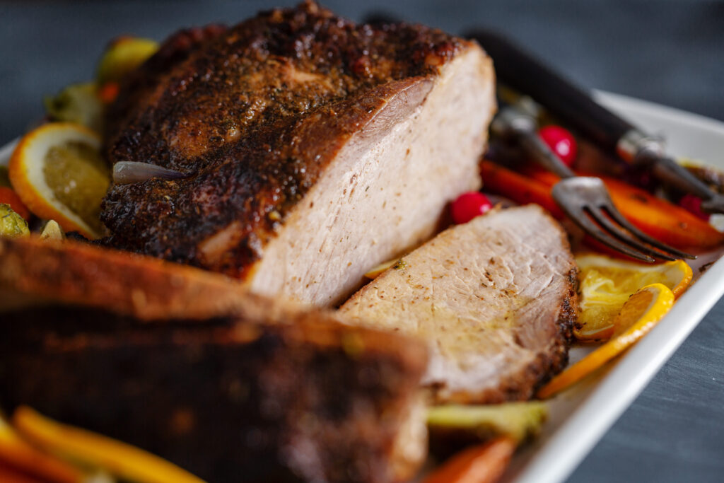 Smoked meatloaf cooking on a smoker grill with a golden, caramelized crust