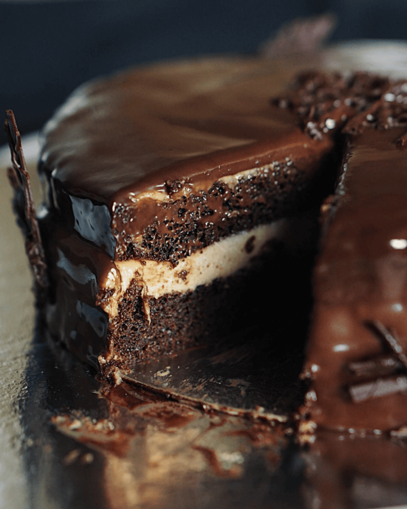 Assembling Chocolate Eclair Cake layers with graham crackers and vanilla pudding in baking dish